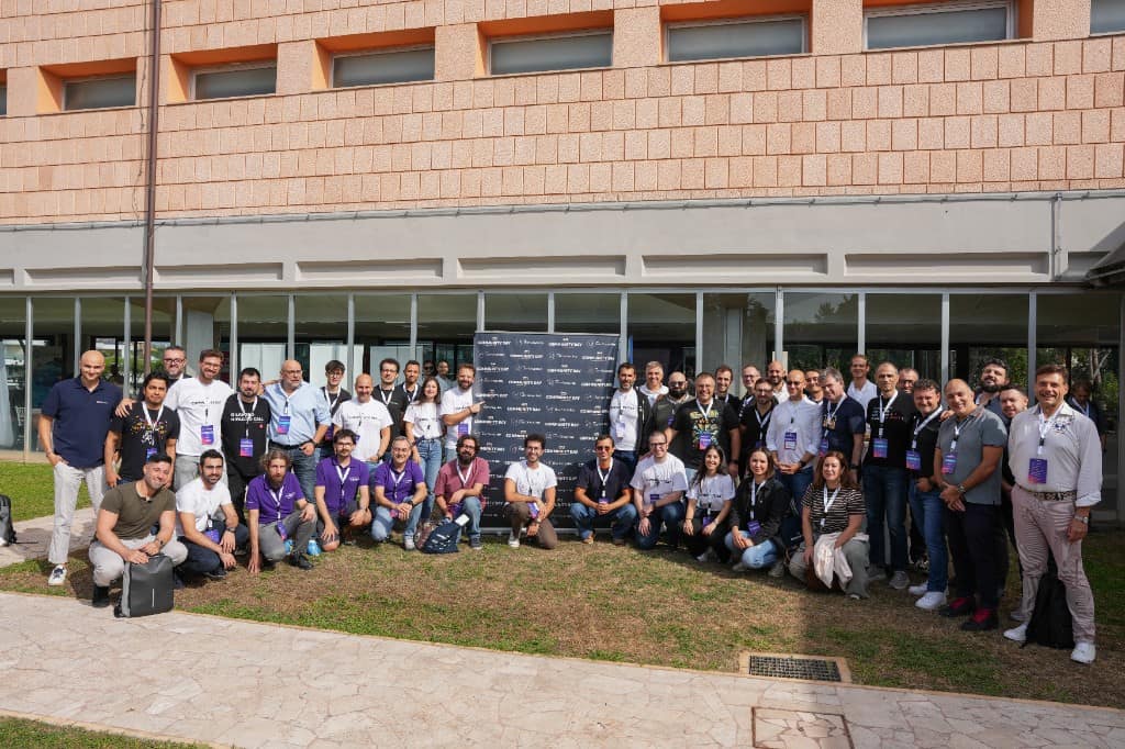 Group photo of attendees, speakers and organisers of AWS Community Day Italy 2026 in front of Hotel Villa Eur